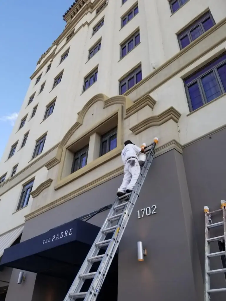 Bakersfield painter working on painting the exterior of a hotel in the downtown area.