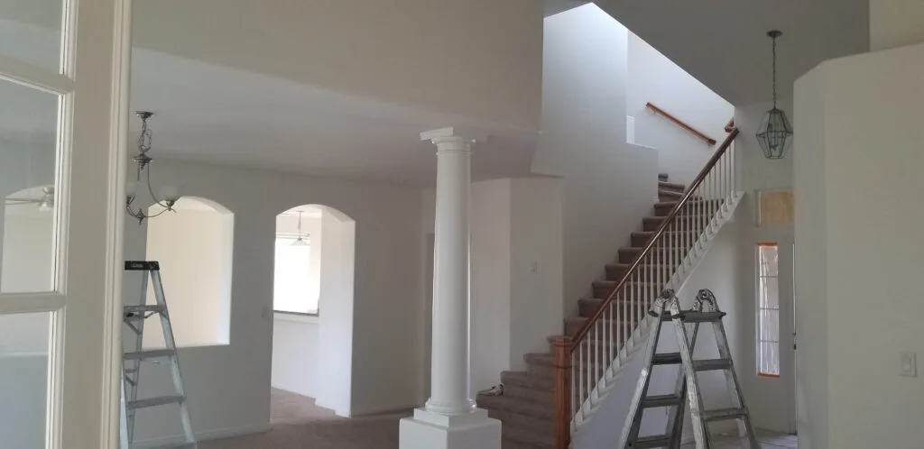 Foyer home entrance with white freshly painted walls and white pillar in Bakersfield, California.