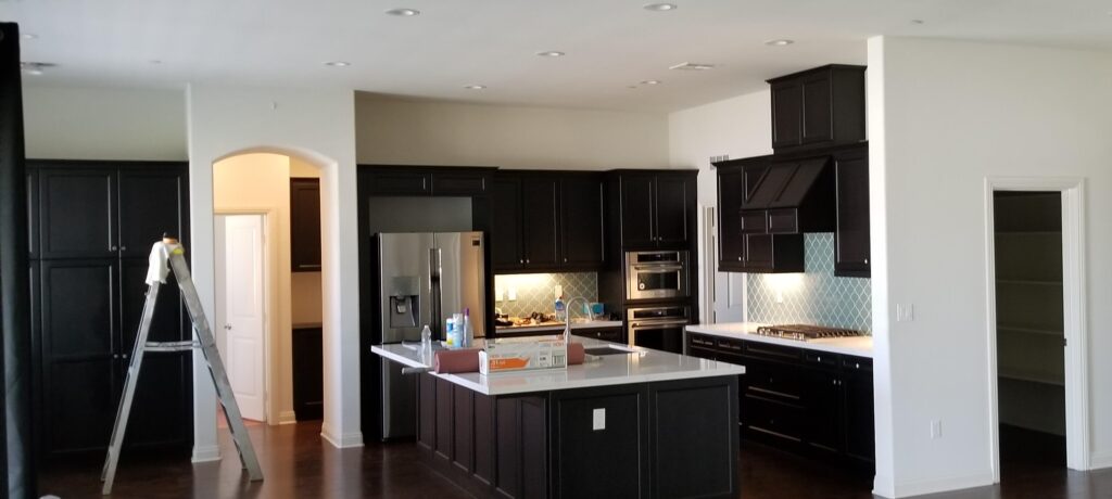 Kitchen cabinets with black paint in large kitchen in Bakersfield, California.