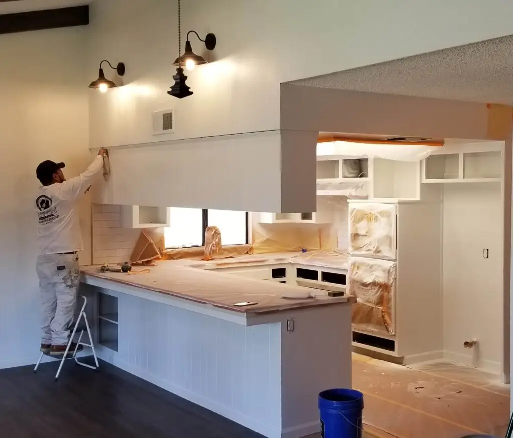 Kitchen cabinets and bathroom painted, with interiors covered in paper, Bakersfield, California.