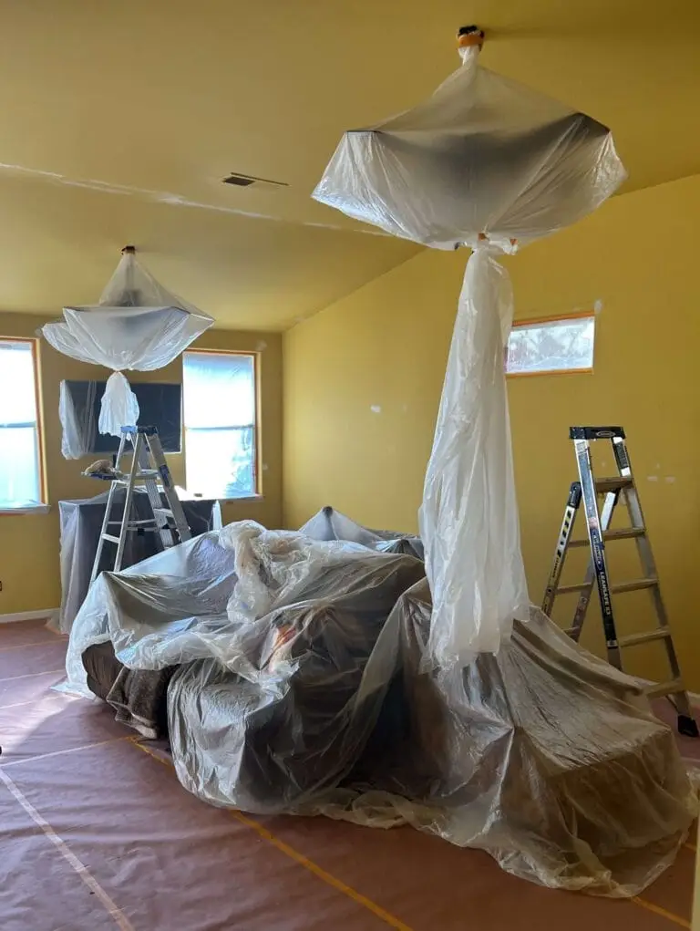 Professional Interior Painting Contractor covering furniture and floors in Bakersfield, CA