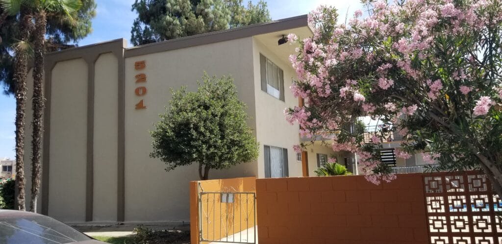 Exterior stucco and fascia painting at a multi-unit apartment complex.
