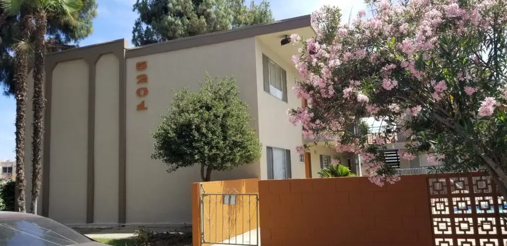 Exterior stucco and fascia painting at a multi-unit apartment complex.