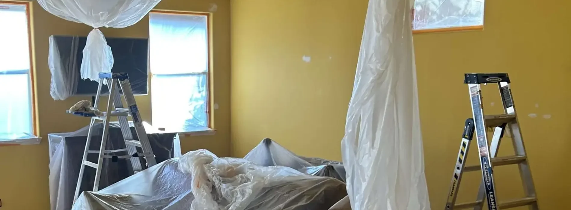 Professional Interior Painting Contractor covering furniture and floors in Bakersfield, CA